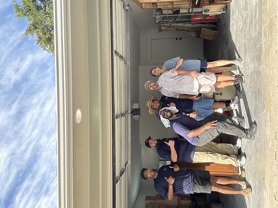 Maltese Movers crew with a happy customer family after a move in College Station, TX