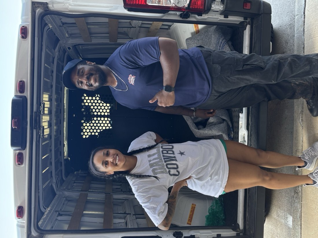 Maltese Movers crew member with a customer in front of a moving van